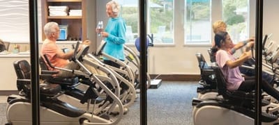 Residents engaged in fitness activity at the facility gym