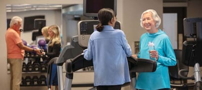 Elderly residents engaging in fitness activities with staff