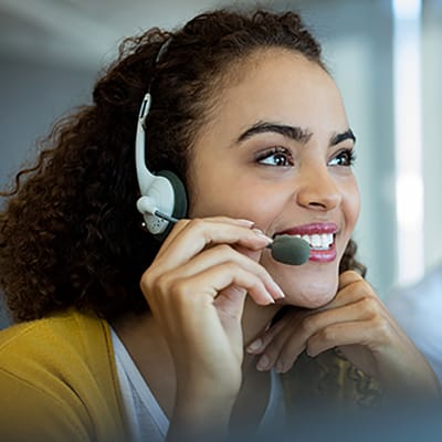 Riverside Care & Rehabilitation Center, nursing home in Owensboro, KY — Woman smiling while wearing a headset and microphone