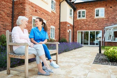 Resident and staff member enjoying time outdoors