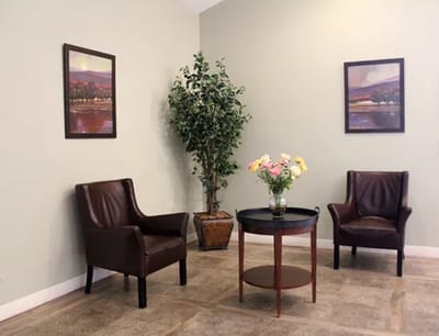 Cozy common area with chairs and a flower arrangement