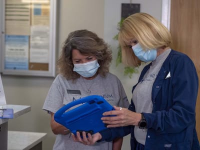 Two staff members reviewing information in an interior setting