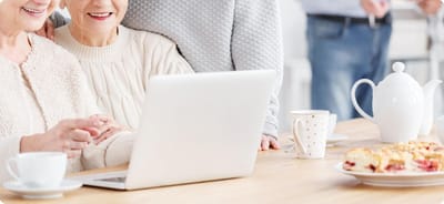 Residents enjoying time together with snacks and a laptop