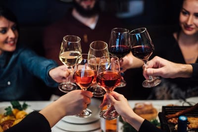 Group toasting with wine glasses at a table