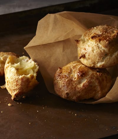 Freshly baked cheese scones on parchment paper