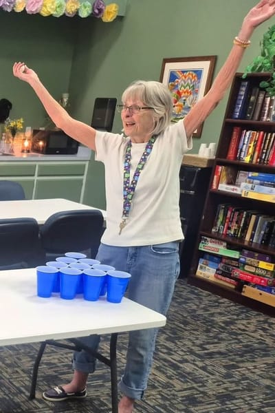 Resident celebrating during a game activity in a common area