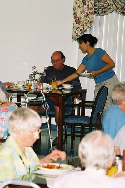 Residents enjoying meals in a dining room setting