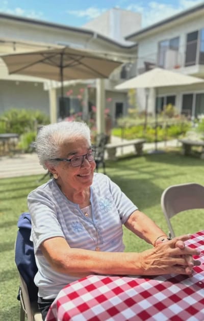 Resident enjoying time outdoors in a garden area