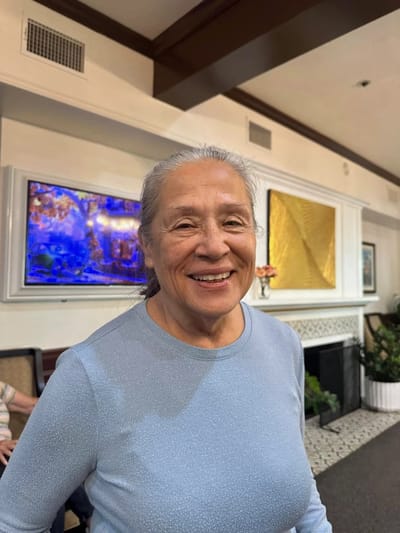 Smiling resident in a bright facility lobby