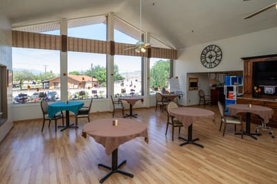 Bright common area with tables and large windows