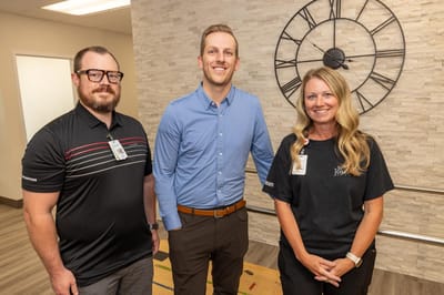 Staff members posing in a well-lit common area
