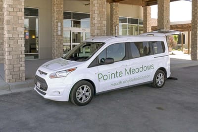 Facility transport vehicle parked outside the entrance