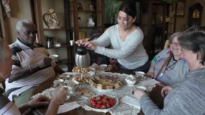 Residents enjoying tea and snacks in a common area