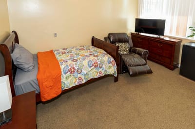 Cozy resident room with bed and recliner