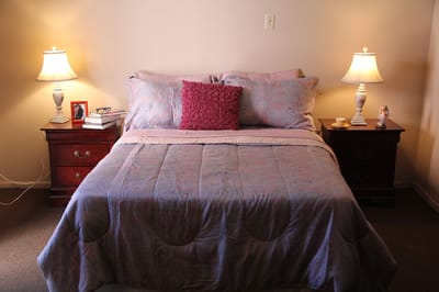 Cozy resident bedroom with lamps and decor