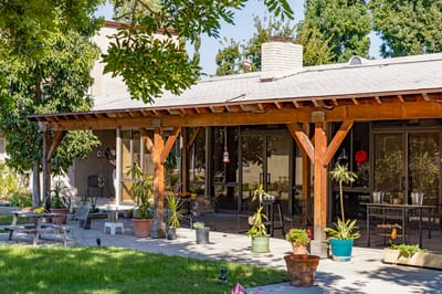 Outdoor patio area with plants and seating