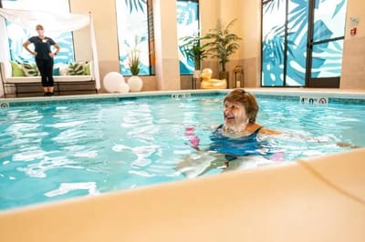Resident enjoying a therapeutic swim in an indoor pool