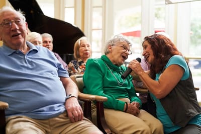 Residents enjoying a musical performance in a common area