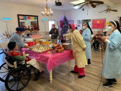 Residents and staff enjoying a festive gathering with food