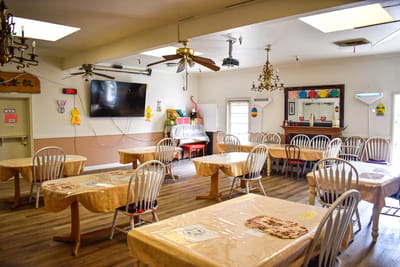 Interior view of a dining area with tables and decor.