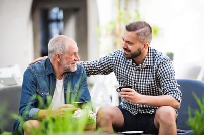 A resident and staff member enjoying a conversation outdoors