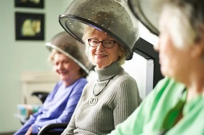 Residents enjoying a hair styling session in a salon