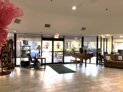 Interior view of a common area with piano and seating