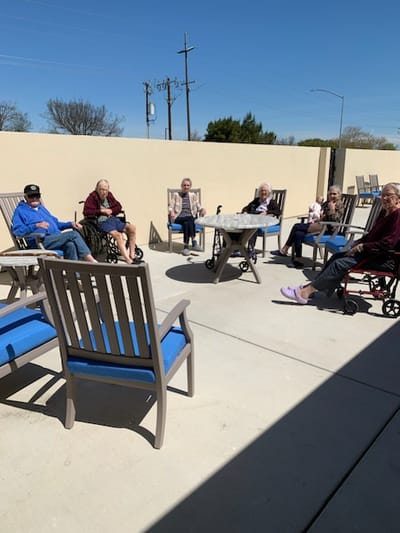Residents enjoying time outdoors in a seating area
