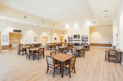 Bright and spacious common area with tables and chairs