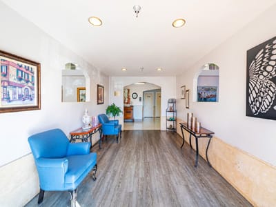 Bright interior hallway with artwork and seating