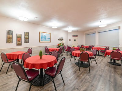 Bright common area with red tablecloths and chairs