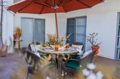 Outdoor seating area with a table and umbrella