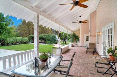 Covered outdoor patio with seating and plants
