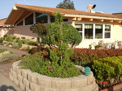 Exterior view of a senior living facility with gardens