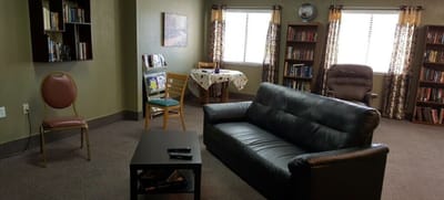 Cozy common area with seating and bookshelves