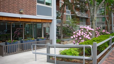 Exterior view of a facility with flowers and seating area