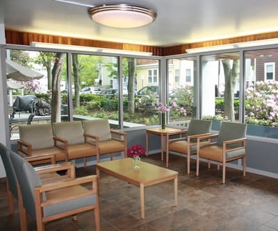 Bright common area with seating and large windows