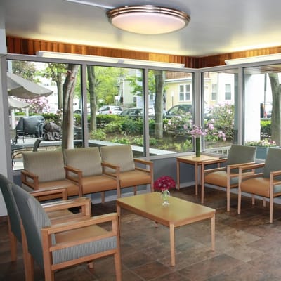 Bright lounge area with seating and views of the garden