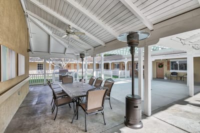 Covered outdoor dining area with tables and chairs
