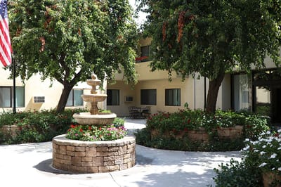 Outdoor courtyard with a fountain and greenery