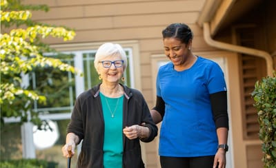 Resident and staff member enjoying a walk outside