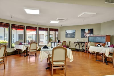 Bright dining room with tables set for meals