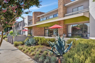 Exterior view of assisted living facility with outdoor seating