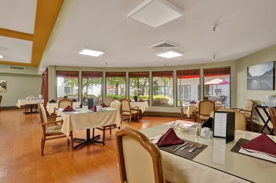 Bright dining room with tables set for meals