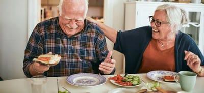 Two elderly residents enjoying a meal together
