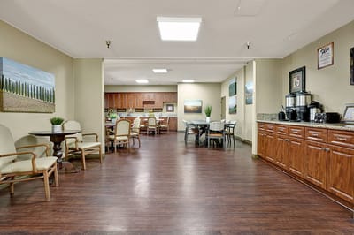 Common area with seating and kitchen in the background