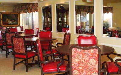 Dining area with red chairs and tables