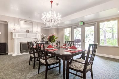 Elegant dining area with chandelier and table settings