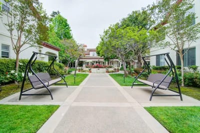 Pathway with seating in a landscaped garden area
