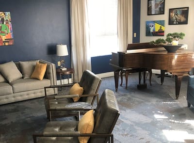 Interior lounge area with piano and seating